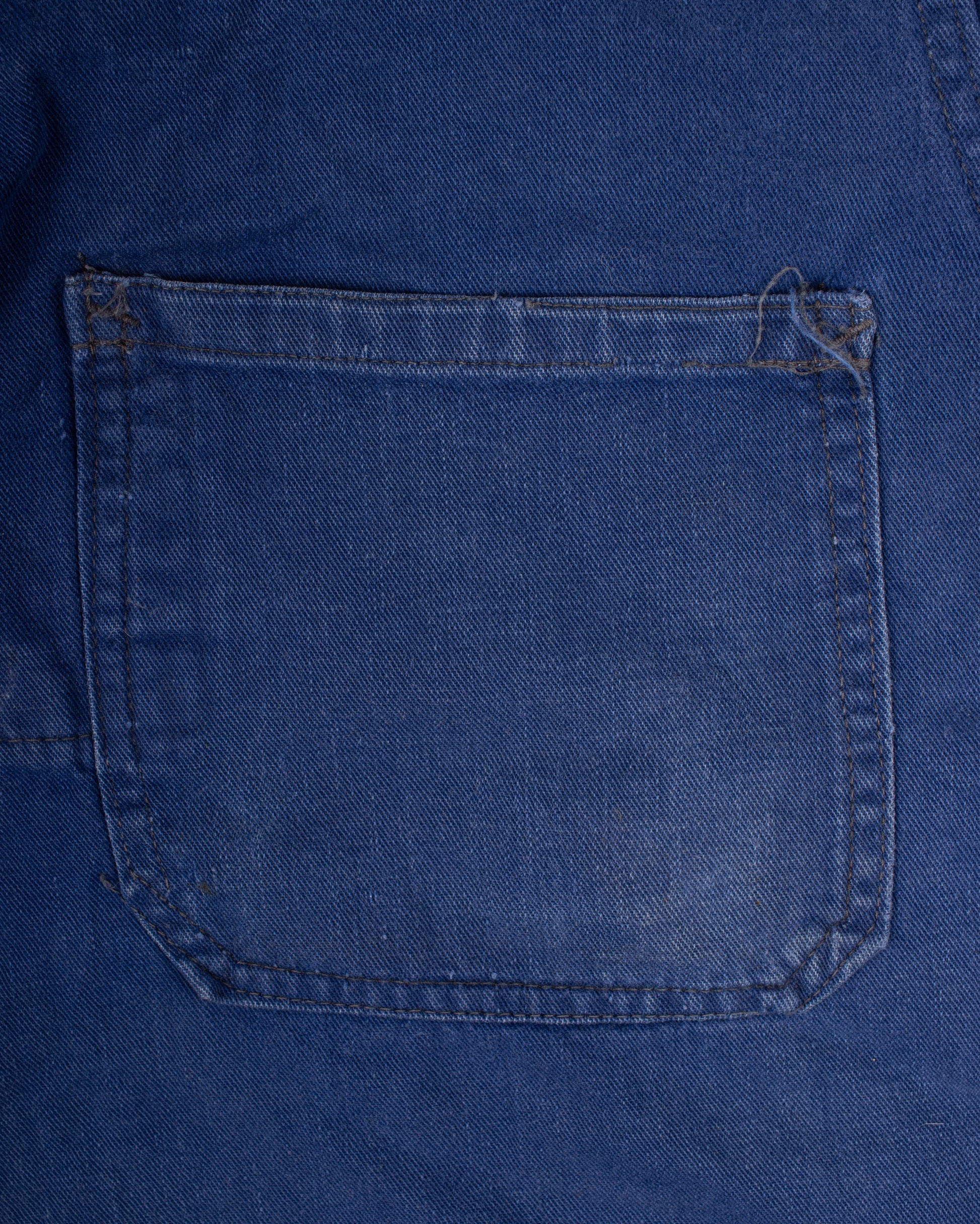 Close-up of a blue denim pocket on a garment french blue vareuse fisherman marin sailor sailing blouse smoke smock jacket overshirt 1960s