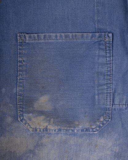 Close-up of a blue denim pocket with visible wear and tear. french blue vareuse fisherman marin sailor sailing blouse smoke smock jacket overshirt 1960s
