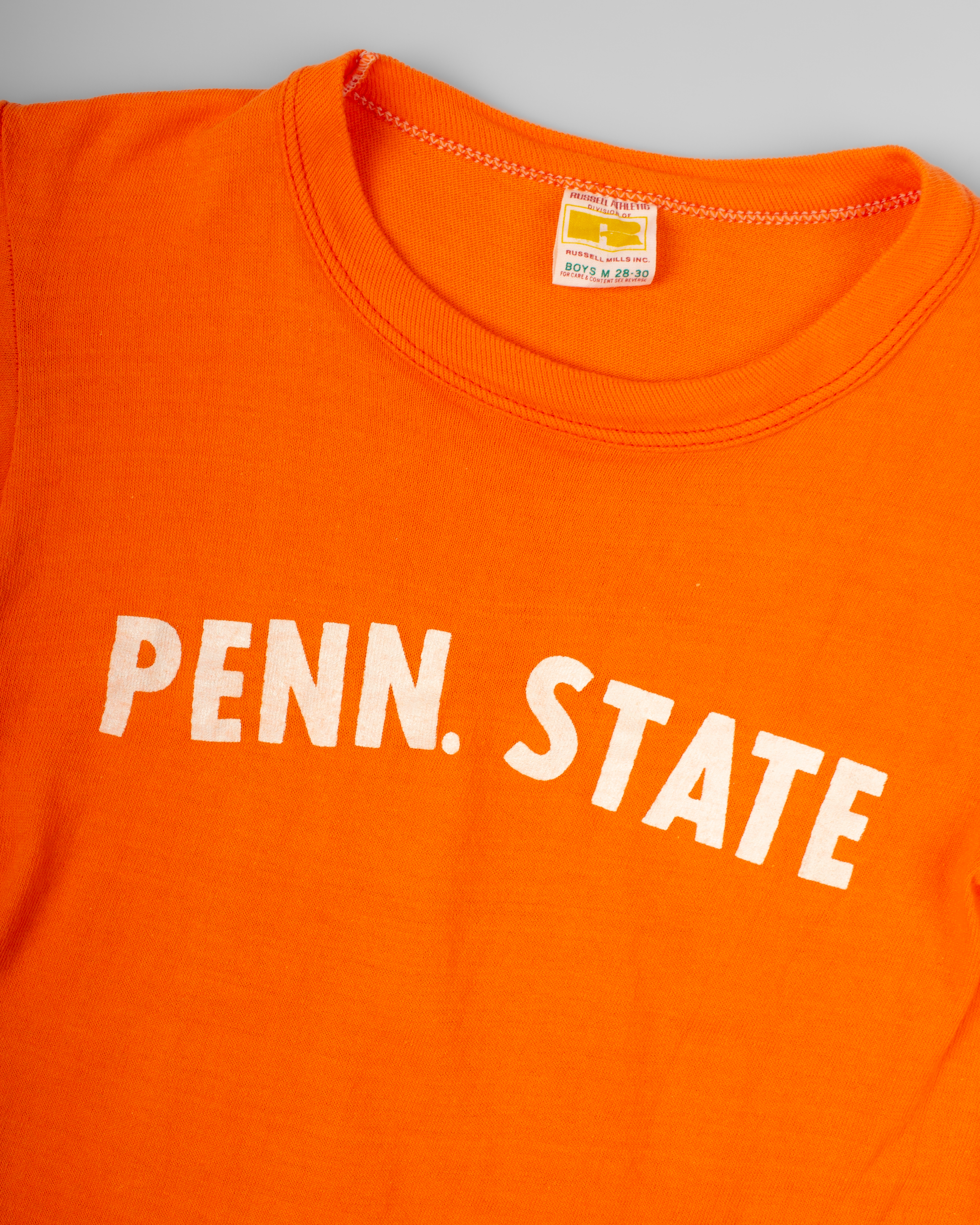 Orange shirt with 'PENN. STATE' text on a gray background single stitch I Love NY I love new york college tee harvard university highschool printed t-shirt 1970s 70s baby tee crop t-shirt vintage cropped tee 